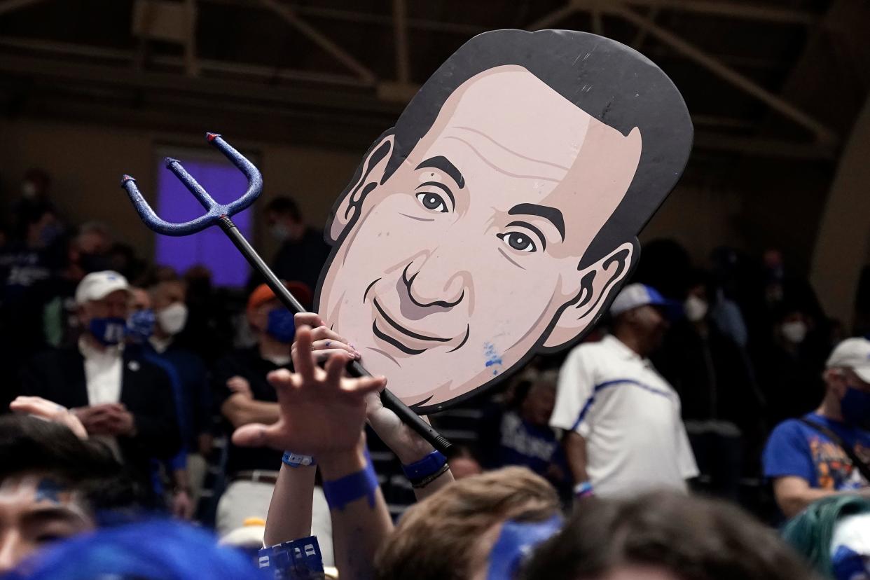 Fans hold an image of Duke coach Mike Krzyzewski prior to an NCAA college basketball game between Duke and North Carolina in Durham, N.C., Saturday, March 5, 2022. The matchup is Krzyzewski's final game at Cameron Indoor Stadium.