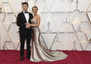 Scarlett Johansson y Colin Jost llevaron a la alfombra roja el glamour del antiguo Hollywood. Ella eligió un vestido de Oscar de la Renta color champán mientras que su pareja lucía un clásico esmoquin negro. (Foto: Richard Shotwell / Invision / AP).