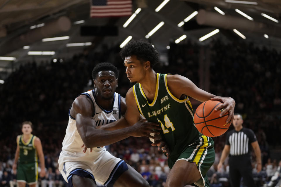 Le Moyne's Ocypher Owens, right, tries to get past Villanova's TJ Bamba during the first half of an NCAA college basketball game, Friday, Nov. 10, 2023, in Villanova, Pa. (AP Photo/Matt Slocum)