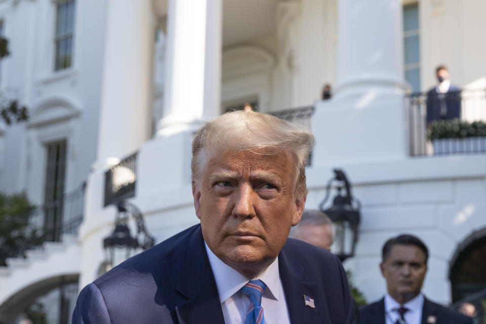 President Donald Trump leans in to hear a question as he speaks with reporters before walking to Marine One on the South Lawn of the White House, Wednesday, July 29, 2020, in Washington. Trump is en route to Texas. (AP Photo/Alex Brandon)