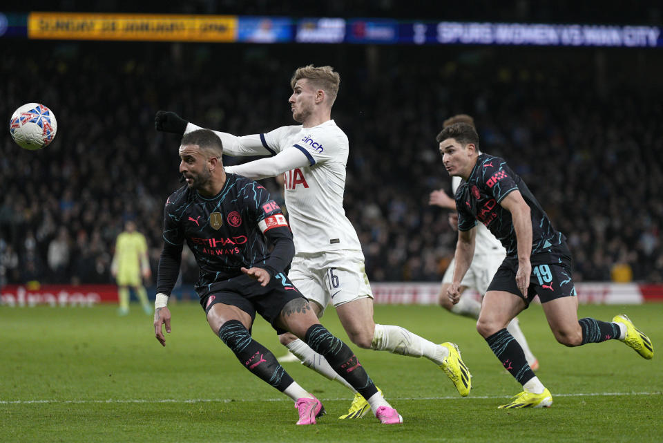 Tottenham's Timo Werner, center, battles for the ball with Manchester City's Kyle Walker, left, and Manchester City's Julian Alvarez during the English FA Cup fourth round soccer match between Tottenham Hotspur and Manchester City in London, Friday, Jan. 26, 2024. (AP Photo/Dave Shopland)