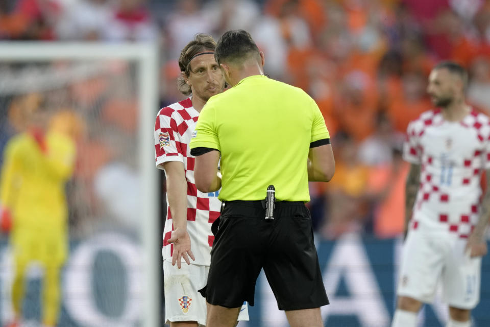 Croatia's Luka Modric talks to Referee Istvan Kovacs during the Nations League semifinal soccer match between the Netherlands and Croatia at De Kuip stadium in Rotterdam, Netherlands, Wednesday, June 14, 2023. (AP Photo/Peter Dejong)