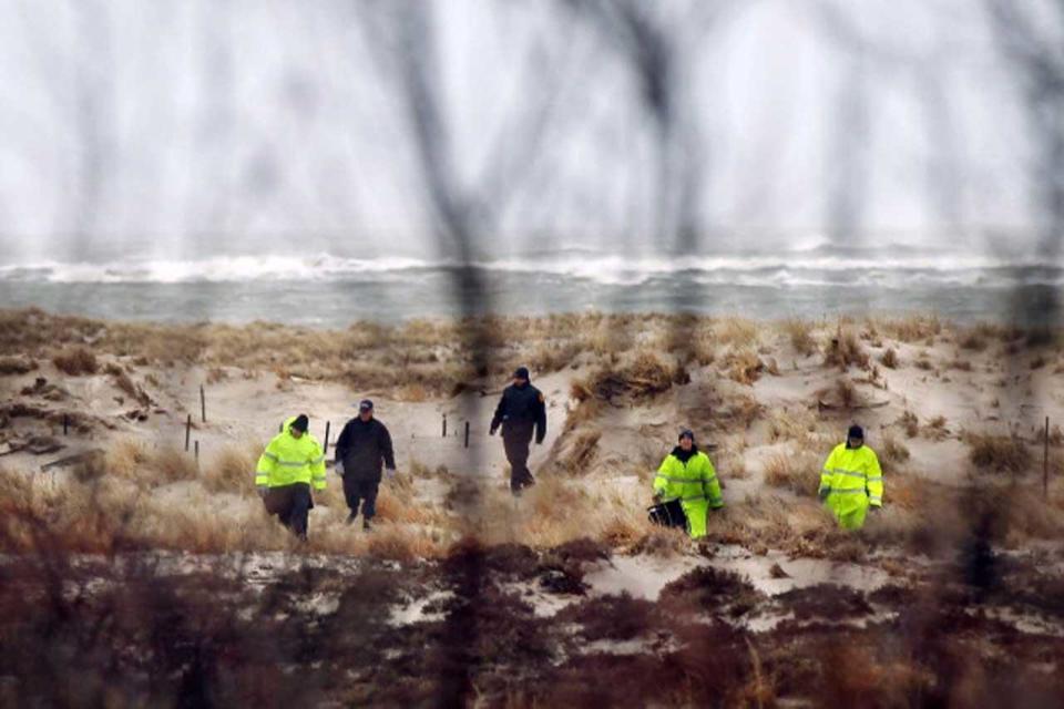 Suffolk County Police and police recruits search an area of beach near where police found human remains on April 5, 2011 in Babylon, New York.  / Credit: Spencer Platt/Getty Images