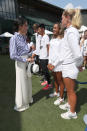 <p>For her debut Wimbledon appearance as a royal – and first solo appearance with the Duchess of Cambridge – Meghan donned a striped shirt and wide-leg trousers from Ralph Lauren. The Duchess finished the look with a low bun and a wide-brim hat, which she didn’t wear but held. <em>[Photo: Getty]</em> </p>