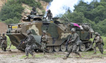 FILE - In this July 6, 2016, file photo, South Korea and U.S. marines participate in a joint military exercise between South Korea and the United States in Pohang, South Korea. The U.S. and South Korean militaries, used to being on guard for threats from North Korea, face a new and formidable enemy that could hurt battle readiness: a virus spreading around the world that has infected more than 1,200 people in South Korea. (Kim Joon-bum/Yonhap via AP, File)