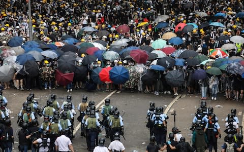 Protesters face off with police during a rally - Credit: DALE DE LA REY/AFP/Getty Images