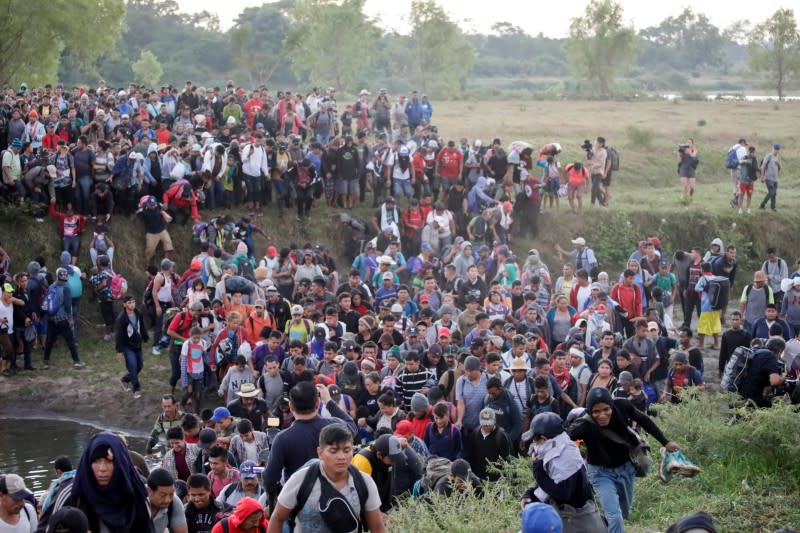 Migrants, mainly from Central America and marching in a caravan, walk after crossing the Suchiate river, on the outskirts of Ciudad Hidalgo