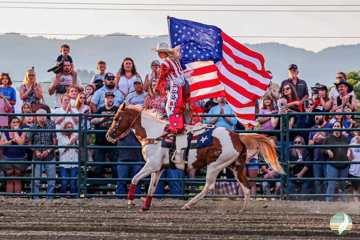 Pictured is Madison County Championship Rodeo's producer, Kenny Treadway's daughter, Kenly Treadway, waving a flag in the Madison County Fair rodeo.