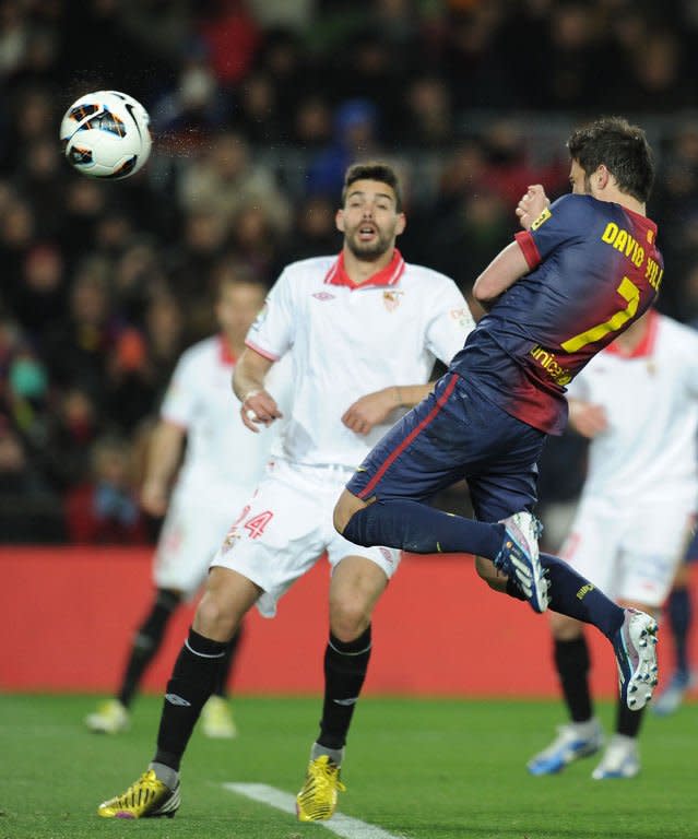 Barcelona's forward David Villa scores during their Spanish league football match against Sevila at the Camp Nou stadium in Barcelona on February 23, 2013. Barcelona won 2-1