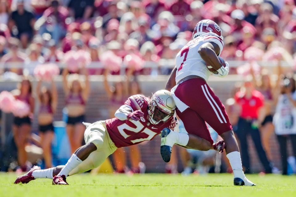 Florida State Seminoles defensive back Akeem Dent (27) tackles Massachusetts Minutemen running back Ellis Merriweather (7). The Florida State Seminoles leads the Massachusetts Minutemen 38-3 at the half Saturday, Oct. 23, 2021.