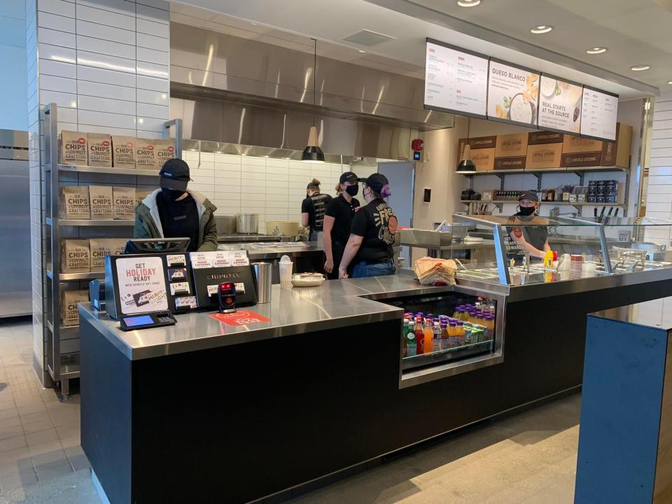 Employees at work in the Chipotle Mexican Grill that recently opened in Plain Township across from the Washington Square shopping area.