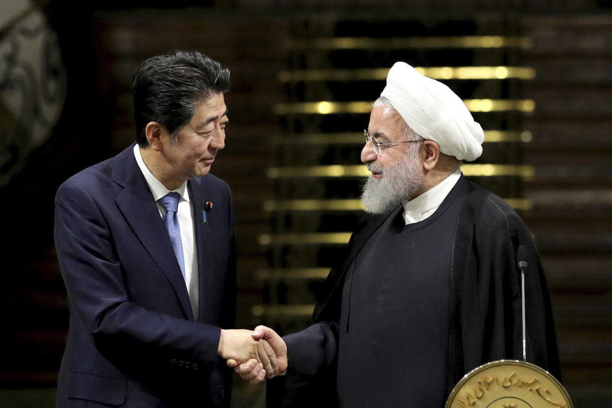 Japanese Prime Minister Shinzo Abe, left, and Iranian President Hassan Rouhani shake hands after a joint press conference at the Saadabad Palace in Tehran on June 12. (Photo: Ebrahim Noroozi/AP)