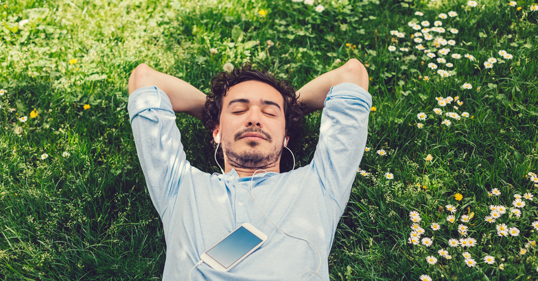 man meditating in field