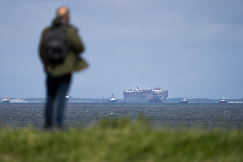 Stricken cargo ship Fremantle Highway, that caught fire while transporting thousands of cars from Germany to Singapore, is towed into the port of Eemshaven, the Netherlands, on Thursday, Aug. 3, 2023. The ship that burned for almost a week close to busy North Sea shipping lanes and a world renowned migratory bird habitat will be salvaged at the northern Dutch port. (AP Photo/Peter Dejong)