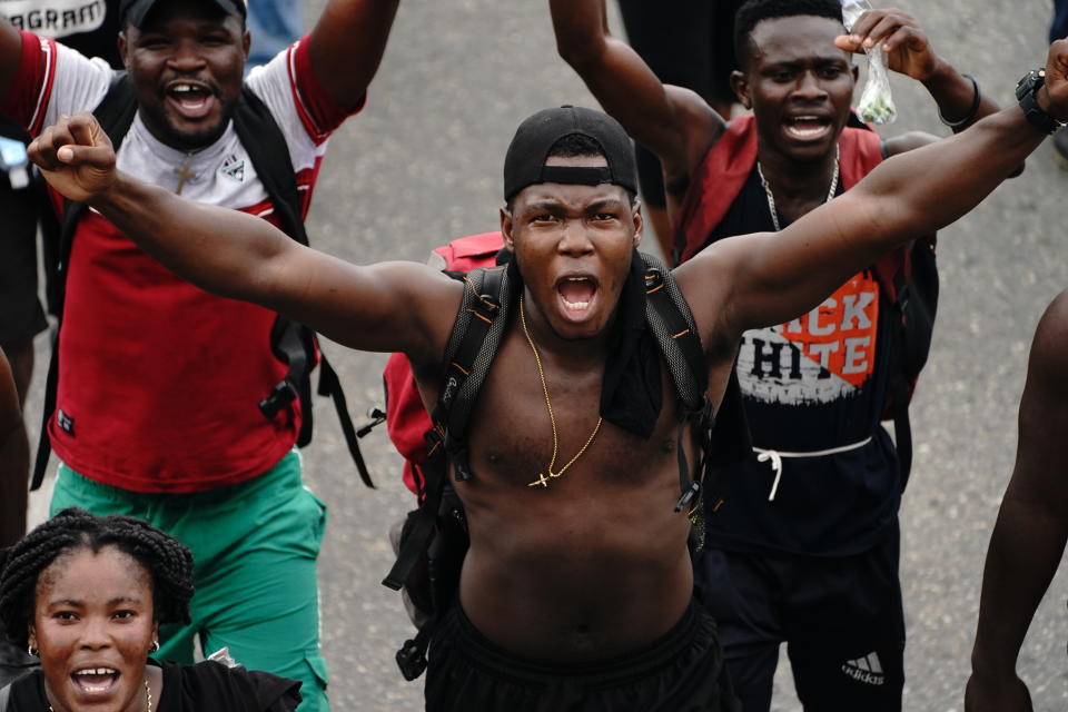 Migrants who are part of a caravan heading north, cheer after passing a checkpoint along the Huehuetan highway, Chiapas state, Mexico, Saturday, Sept. 4, 2021. (AP Photo/Marco Ugarte)