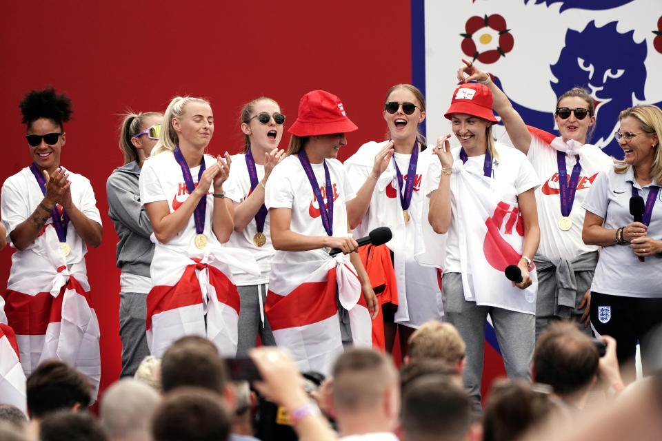 England's Ella Toone (centre, left) and Leah Williamson on stage with head coach Sarina Wiegman (right) and team mates during a fan celebration to commemorate England's historic UEFA Women's EURO 2022 triumph in Trafalgar Square, London. Picture date: Monday August 1, 2022.