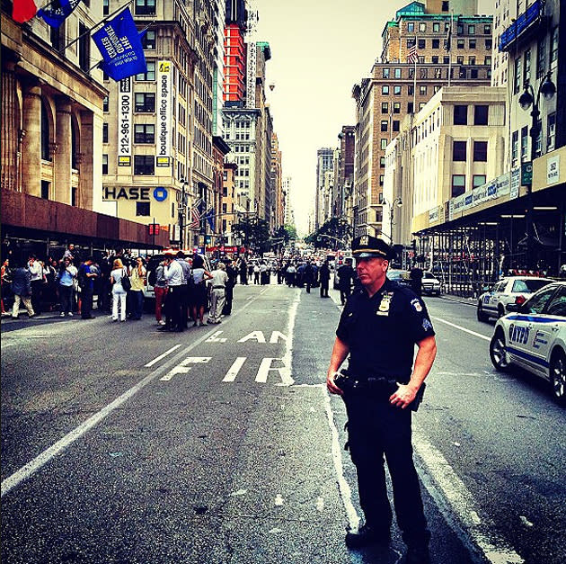 A policeman stands on the scene of a tragic shooting at the Empire State Building in New York City. Twitter photo courtesy of Holly Bailey (@hollybdc)