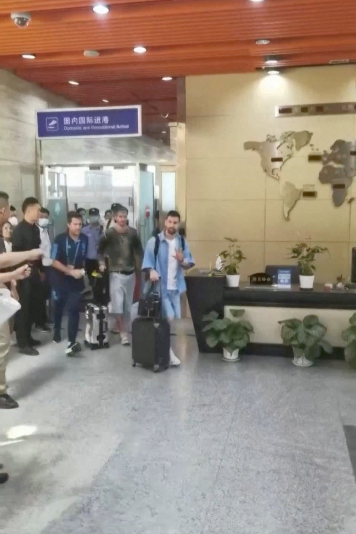 Messi arriving at Beijing airport shortly before the passport-related drama (via REUTERS)