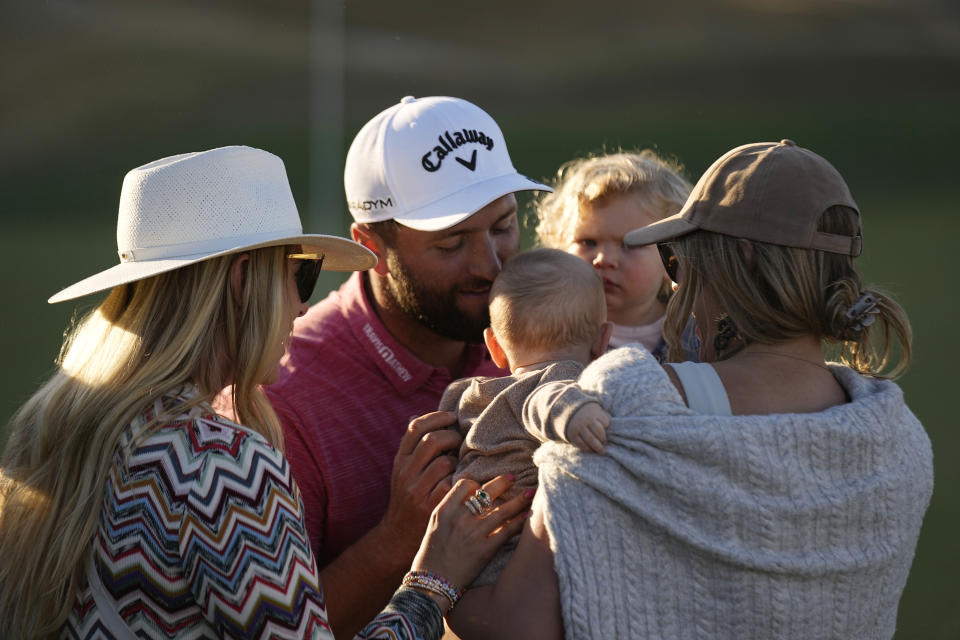Jon Rahm hugs his family after winning the American Express golf tournament on the Pete Dye Stadium Course at PGA West Sunday, Jan. 22, 2023, in La Quinta, Calif. (AP Photo/Mark J. Terrill)