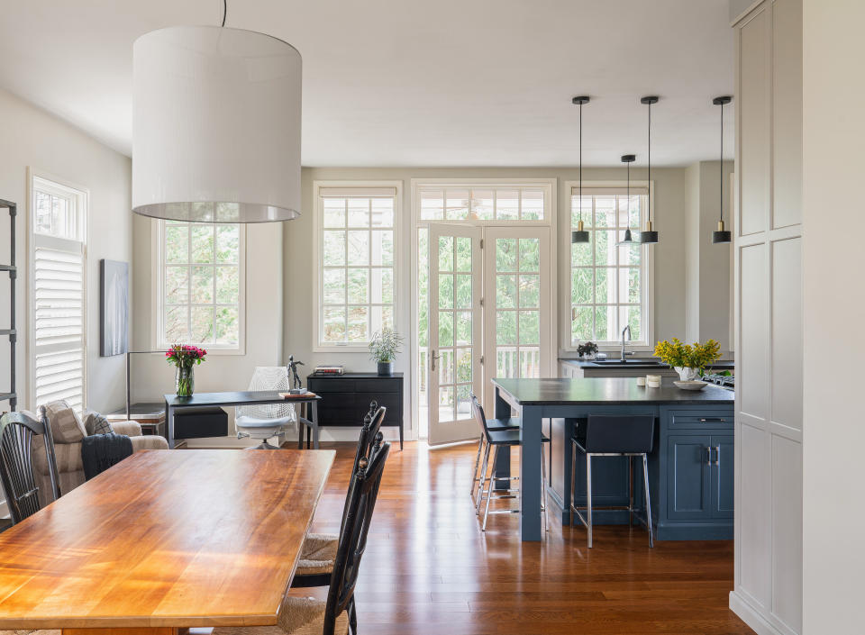 Kitchen dining room with blue island and wood floor