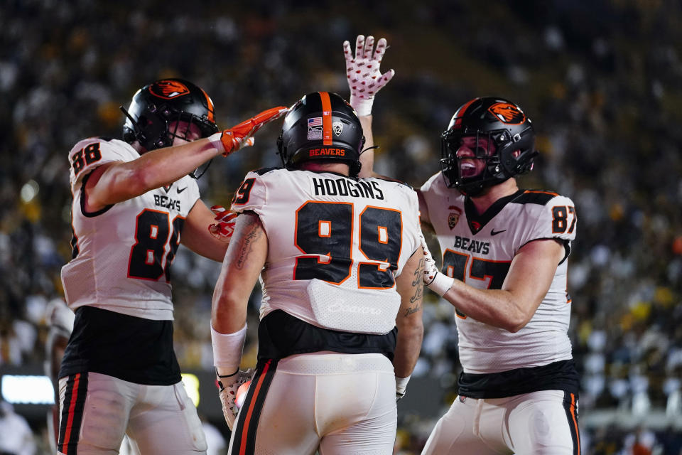 Oregon State defensive lineman Isaac Hodgins, center, celebrates with teammates after scoring on a touchdown reception against California during the second half of an NCAA college football game Saturday, Oct. 7, 2023, in Berkeley, Calif. (AP Photo/Godofredo A. Vásquez)