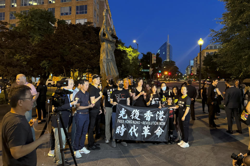 People gather at the base of the Victims of Communism Memorial during a candlelight vigil to mark the 35th anniversary of the Tiananmen Square, Tuesday, June 3, 2024, in Washington. (AP Photo/Didi Tang)