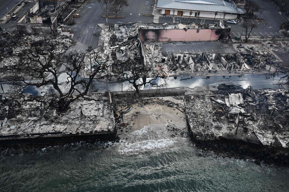 An aerial photo shows charred homes along Lahaina's waterfront. / Credit: PATRICK T. FALLON/AFP via Getty Images