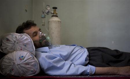 Fayegh Fallahi, who was injured in an Iraqi chemical attack during the 1980-1988 Iran-Iraq war, uses oxygen as he rests at his home in Nowdesheh in Kermanshah province 680 km (425 miles) southwest of Tehran in this July 5, 2008 file photo. REUTERS/Morteza Nikoubazl
