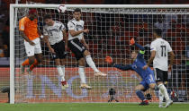 Netherland's Ryan Babel, Germany's Jonas Hector and Mats Hummels, from left, jump for the ball in front of Germany's keeper Manuel Neuer during the UEFA Nations League soccer match between The Netherlands and Germany at the Johan Cruyff ArenA in Amsterdam, Saturday, Oct. 13, 2018. (AP Photo/Peter Dejong)