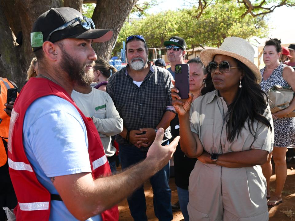 Oprah Winfrey meets people at a distribution and aid site at Honokowai Beach Park on Sunday August 13, 2023 in Honokowai, HI.