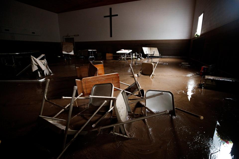 A church on Thursday, shown with water damage and seats strewn over the floor after flooding in Buchanan County (AP)