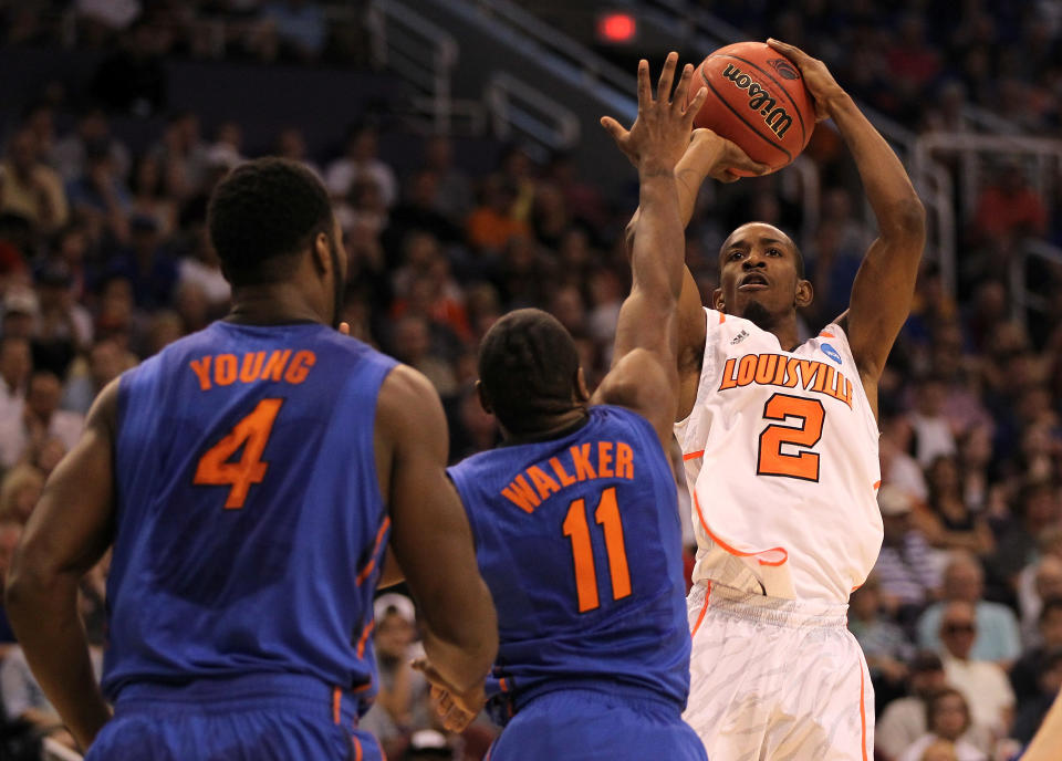 PHOENIX, AZ - MARCH 24: Russ Smith #2 of the Louisville Cardinals shoots over Erving Walker #11 of the Florida Gators in the first half during the 2012 NCAA Men's Basketball West Regional Final at US Airways Center on March 24, 2012 in Phoenix, Arizona. (Photo by Jamie Squire/Getty Images)