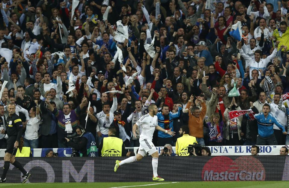 Real's Karim Benzema celebrates after scoring his side's first goal during a first leg semifinal Champions League soccer match between Real Madrid and Bayern Munich at the Santiago Bernabeu stadium in Madrid, Spain, Wednesday, April 23, 2014. (AP Photo/Andres Kudacki)