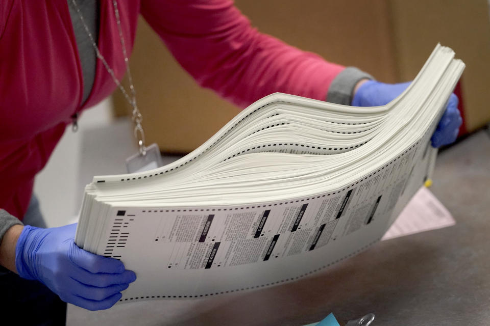 An election worker boxes tabulated ballots inside the Maricopa County Recorders Office, Wednesday, Nov. 9, 2022, in Phoenix. (AP Photo/Matt York)