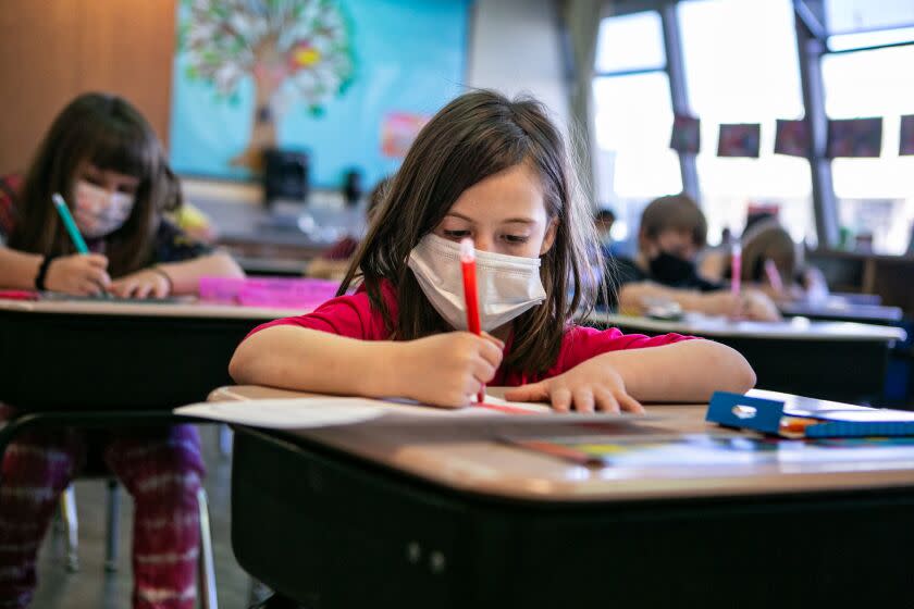 WEAVERVILLE, CA - MARCH 02: Students in Mrs. Darsi Green's, 2nd grade class at Weaverville Elementary School make Dr. Seuss hats on March. 02, 2021 in Weaverville, CA. Rural schools in Northern California have managed to stay open for in person learning during the pandemic(Jason Armond / Los Angeles Times)