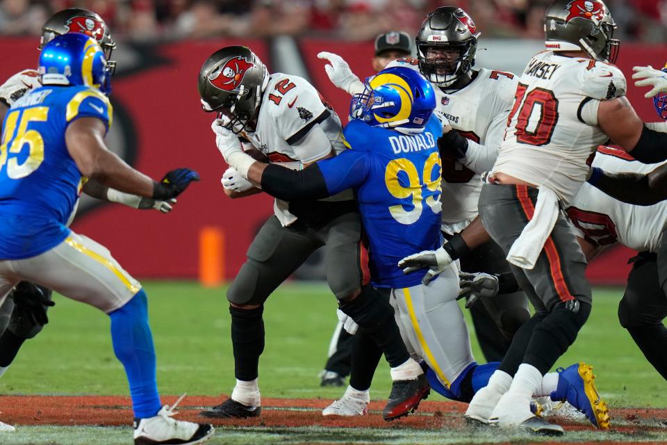 Los Angeles Rams defensive tackle Aaron Donald (99) sacks Tampa Bay Buccaneers quarterback Tom Brady (12) during the second half of an NFL football game between the Los Angeles Rams and Tampa Bay Buccaneers, Sunday, Nov. 6, 2022, in Tampa, Fla. (AP Photo/Chris O'Meara)