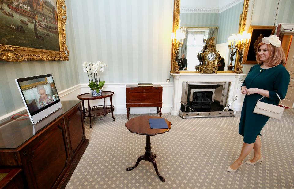 <p>Queen Elizabeth II appears on a screen by videolink from Windsor Castle, where she is in residence, during a virtual audience to receive the Ambassador of Romania Laura Popescu at Buckingham Palace, London. Picture date: Wednesday May 12, 2021.</p>
