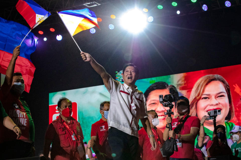 Ferdinand 'Bongbong' Marcos Jr. waves a Philippine flag during at a campaign rally on May 7, 2022 in Manila.<span class="copyright">Ezra Acayan—Getty Images</span>