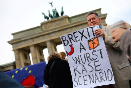 A demonstrator holds a sign during a rally under the slogan "Stop the Coup" to protest against attempts to force through a no-deal Brexit, in Berlin