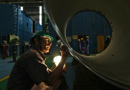 An employee works on the production line inside the heavy electrical manufacturing unit of Larsen & Turbo in Mumbai December 4, 2013. REUTERS/Mansi Thapliyal