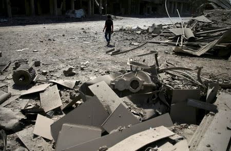 A man walks at a site hit by an airstrike in the rebel held Douma neighbourhood of Damascus, Syria August 22, 2016. REUTERS/Bassam Khabieh