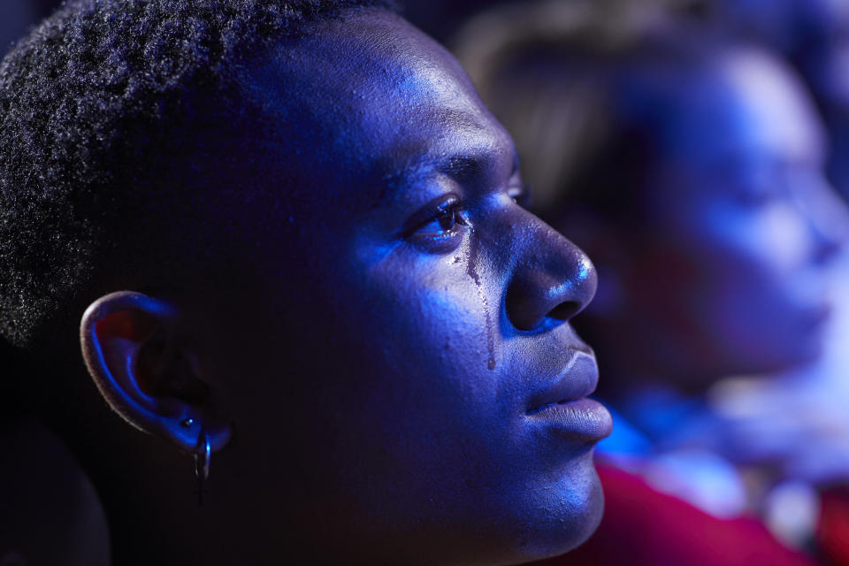 Close up of man crying while watching movie