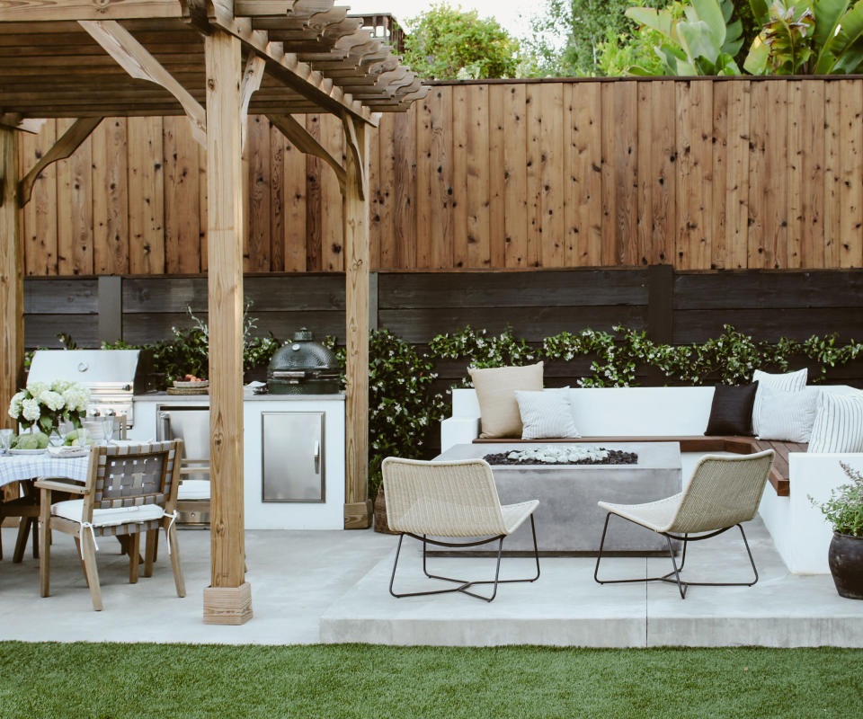 backyard with outdoor kitchen and seats round fire pit