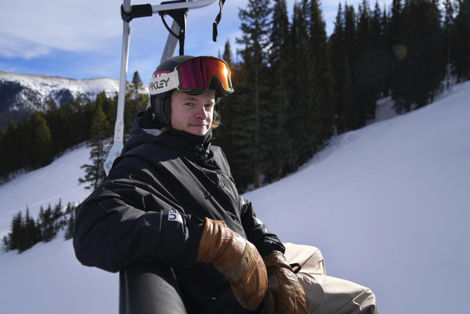 Olympic snowboarder Taylor Gold, of the United States, rides a chair lift on Dec. 21, 2021, in Copper Mountain, Colo. Olympic athletes in Alpine skiing and other outdoor sports dependent on snow are worried as they see winters disappearing. “The absolute ideal scenario would be to have a halfpipe made entirely of natural snow, but that’s just never possible anymore," Gold said. (AP Photo/Brittany Peterson)