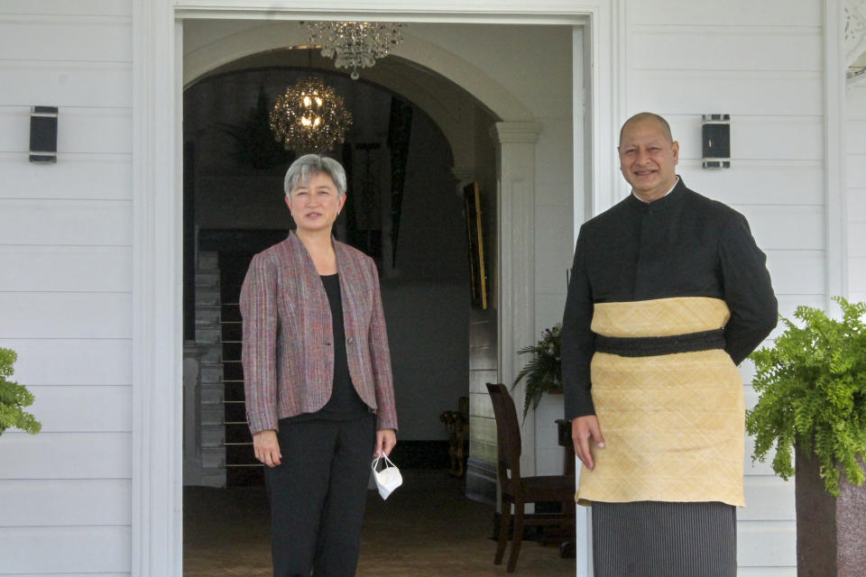 In this photo supplied by the Australian Department of Foreign Affairs, Australia's Minister for Foreign Affairs, Penny Wong, left, poses for a photo with the King of Tonga, Tupou VI in Nuku'alofa, Tonga, Friday, June 3, 2022. (Marian Kupu/Australian Department of Foreign Affairs via AP)