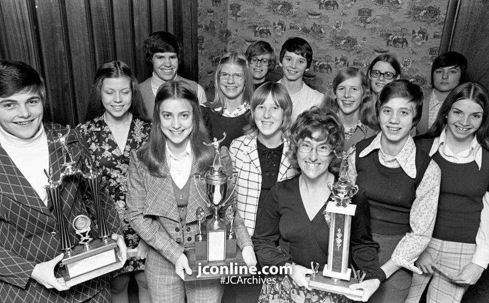 Harrison honored its state vollebyball finalists at an award fete with top individual honors going to Pam Dahnke, best mental attitude and captain) and Julie Kepner, most valuable. Holiding the other trophy is Coach Betty Holyard. Harrison won 21 of 22 dual meets and captured the Hoosier Conference title. From left, front row, are Pam Dahnke, Jule Liska, Judy Fithian, Deb Lawson, Bolyard, Belinda Griggs and Cathy Yancey; back row: Sharon Wettschurack, Kathy Plantenga, Karen Ramsey, Cathy Estridge, Julie Kepner, Gail Ramsey and Pam Franz. Photo taken Dec 4, 1974.