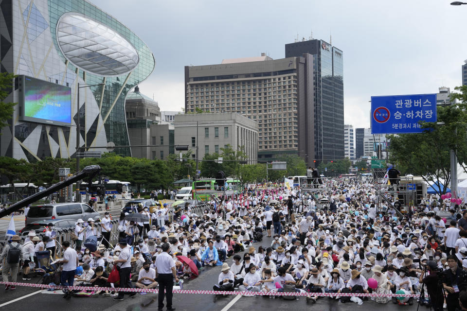 People gather before a rally opposing the Seoul Queer Culture Festival in Seoul, South Korea, Saturday, July 16, 2022. Thousands of gay rights supporters marched under a heavy police guard in the South Korean capital on Saturday as they celebrated the city's first Pride parade in three years after a COVID-19 hiatus. (AP Photo/Lee Jin-man)