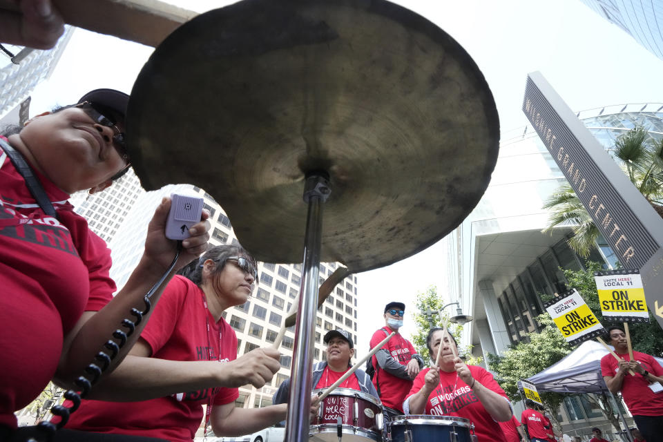 Striking hotel workers play drums as they rally outside the Intercontinental Hotel on Monday, July 3, 2023, in downtown Los Angeles. (AP Photo/Damian Dovarganes)