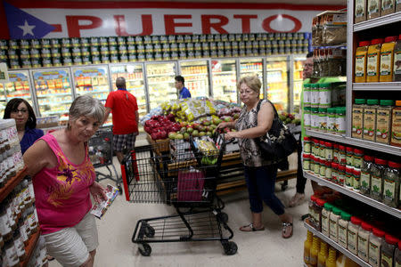 People buy groceries at Willers Supermarket which specialises in Puerto Rican products, in Kissimmee, Florida, U.S., December 3, 2017. REUTERS/Alvin Baez