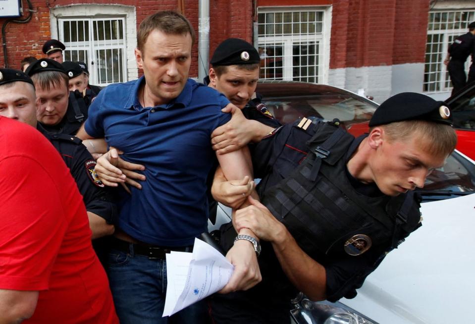Police officers detain Navalny after he registered as a mayoral election candidate in July 2013 (Reuters)
